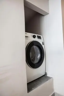 a washing machine in a niche in a wall at Bentzi...Boutique Apartment 1, Classic Double with kitchenette, 2 Guests in Athens