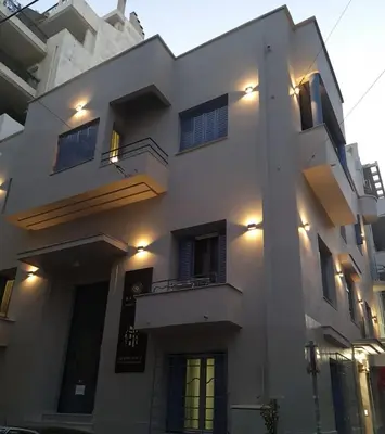 a white building with lights on the side of it at Bentzi...Boutique Apartment 1, Classic Double with kitchenette, 2 Guests in Athens