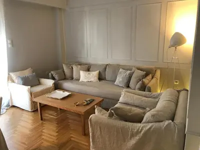 a living room with a couch and a coffee table at API Projects Kolonaki - Casa Academia in Athens