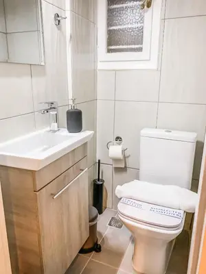 a white bathroom with a toilet and a sink at API Projects Kolonaki - Casa Academia in Athens