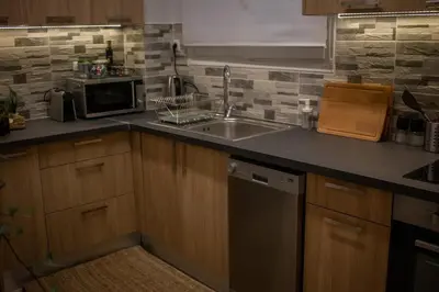 a kitchen with a sink and a microwave at API Projects Kolonaki - Casa Academia in Athens