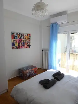 a bedroom with a bed with two towels on it at Cinema Lovers in Athens