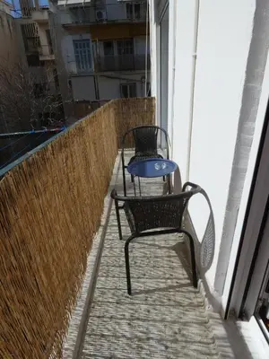 two chairs and a table on a balcony at Cinema Lovers in Athens