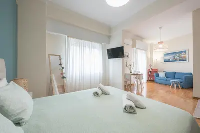 a bedroom with a large bed with towels on it at Paris & Helen in Athens