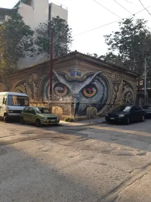 a wall with an eye painted on it at Paris & Helen in Athens