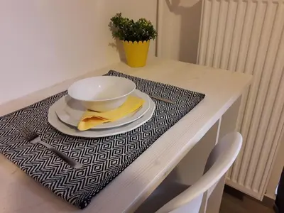 a table with a bowl and a plate on a table at Kolonaki Luxury backyard Studio in Athens