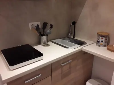 a kitchen with a sink and a counter top at Kolonaki Luxury backyard Studio in Athens
