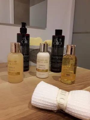 a group of four bottles of hair products on a table at Kolonaki Luxury backyard Studio in Athens