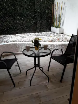 a table and two chairs on a patio at Kolonaki Luxury backyard Studio in Athens