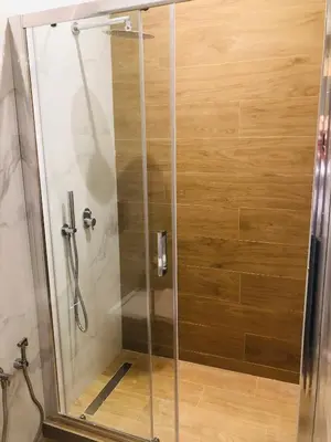 a shower with a glass door in a bathroom at Metropolitan Complex Suite 2@faliro in Piraeus