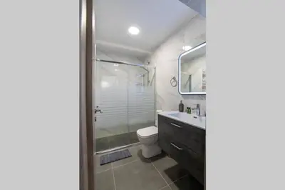 a bathroom with a shower and a toilet and a sink at Brand New Aprt with backyard in Lycabettus Hill ! in Athens
