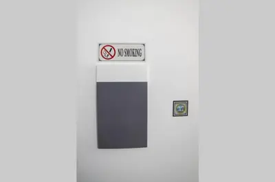 a no smoking sign on the side of a building at Brand New Aprt with backyard in Lycabettus Hill ! in Athens