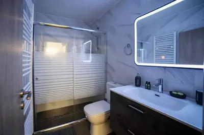 a bathroom with a toilet and a sink and a shower at Brand New Aprt with backyard in Lycabettus Hill ! in Athens