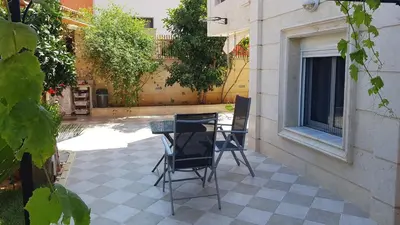 a table and chairs sitting on a patio at Renovated lovely apartment near airport & sea in Porto Rafti