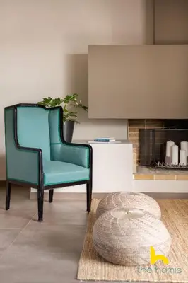 a living room with two chairs and a rug at Penthouse with Magical Acropolis view from Balcony in Athens