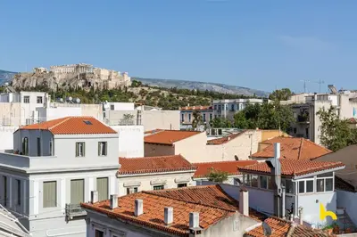 a view of roofs of buildings in a city at Penthouse with Magical Acropolis view from Balcony in Athens