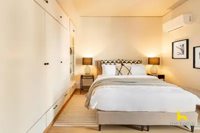 a bedroom with a large bed and two lamps at Penthouse with Magical Acropolis view from Balcony in Athens