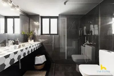 a bathroom with two sinks and a toilet at Penthouse with Magical Acropolis view from Balcony in Athens