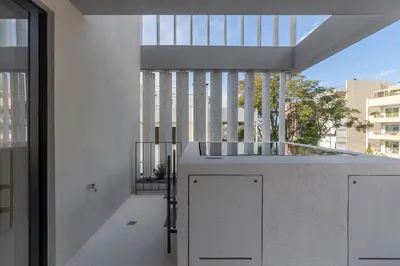 a room with a balcony with a large window at Ogarden in Athens