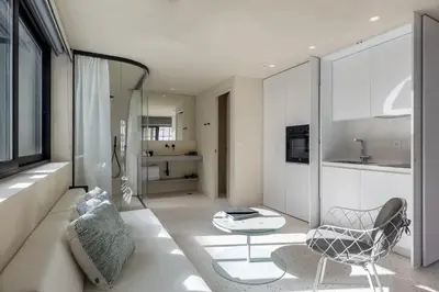 a living room with a chair and a table at Ogarden in Athens