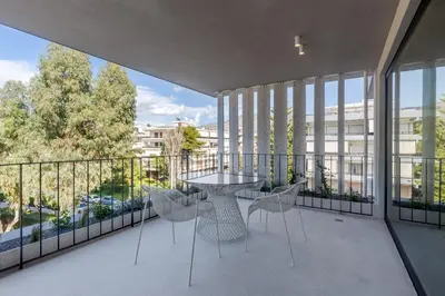 a balcony with a table and chairs on it at Ogarden in Athens