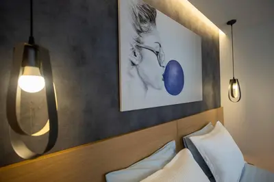 a hotel room with a bed and a picture on the wall at Triple A - Prime Location - Between Monastiraki & Syntagma Square-FREE Parking! in Athens
