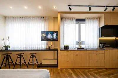 a bedroom with a bed and a kitchen with a counter at Triple A - Prime Location - Between Monastiraki & Syntagma Square-FREE Parking! in Athens