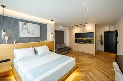 a bedroom with a bed and a living room at Triple A - Prime Location - Between Monastiraki & Syntagma Square-FREE Parking! in Athens