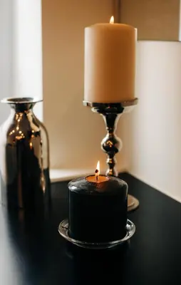 a candle sitting on a table next to a candlesticks at Triple A - Prime Location - Between Monastiraki & Syntagma Square-FREE Parking! in Athens