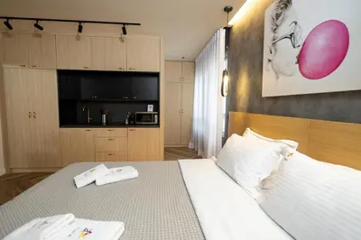 a bedroom with a bed with two white towels on it at Triple A - Prime Location - Between Monastiraki & Syntagma Square-FREE Parking! in Athens