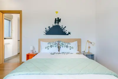 a bedroom with a bed with a statue on top of it at Your Home2b in Paianía