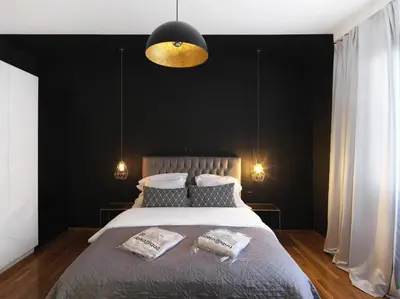 a bedroom with a large bed with a black wall at Athenian Apartment in the center with Jacuzzi in Athens