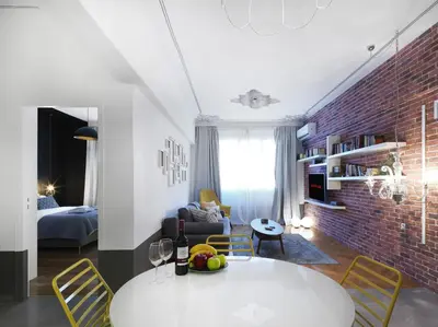 a living room with a white table and a brick wall at Athenian Apartment in the center with Jacuzzi in Athens