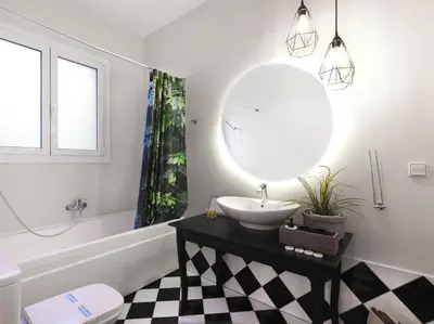 a bathroom with a sink and a mirror at Athenian Apartment in the center with Jacuzzi in Athens