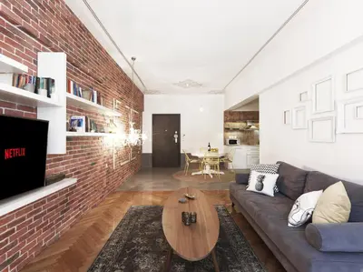 a living room with a couch and a brick wall at Athenian Apartment in the center with Jacuzzi in Athens