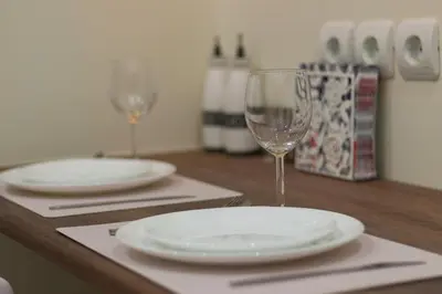 two empty wine glasses sitting on a wooden table at WHITE HOUSE 30 steps from the Metro station in Athens