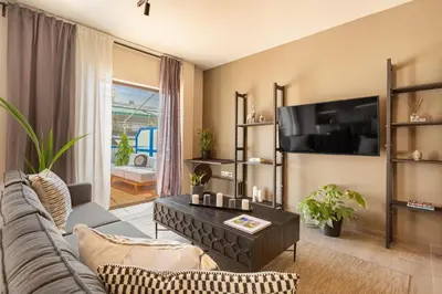 a living room with a couch and a coffee table at Acropolis View 2-Bedroom Apt, Minimal-Safari Vibe, Big Balcony! in Athens