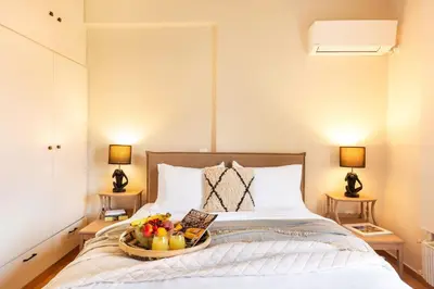 a bedroom with a bed with a tray of fruit on it at Acropolis View 2-Bedroom Apt, Minimal-Safari Vibe, Big Balcony! in Athens