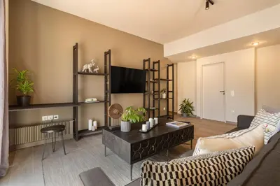 a living room with a couch and a tv at Acropolis View 2-Bedroom Apt, Minimal-Safari Vibe, Big Balcony! in Athens