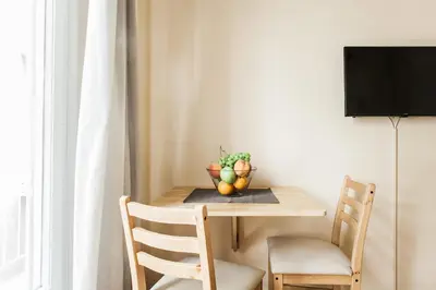 a dining room table with a bowl of fruit on it at La casa di Plaka in Athens