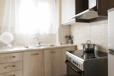 a kitchen with a stove and a sink at La casa di Plaka in Athens