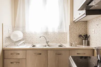 a kitchen with a sink and a window at La casa di Plaka in Athens