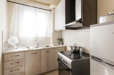 a small kitchen with a stove and a refrigerator at La casa di Plaka in Athens