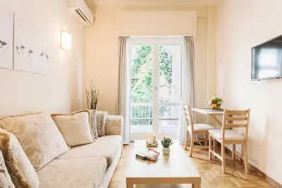 a living room with a couch and a table at La casa di Plaka in Athens