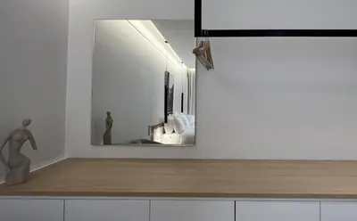 a mirror on a wall above a counter in a room at The Dazzling Glimpse Acropolis Suites in Athens