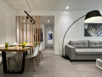 a dining room with a table and a couch at The Dazzling Glimpse Acropolis Suites in Athens