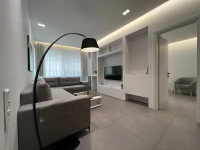 a living room with a couch and a television at The Dazzling Glimpse Acropolis Suites in Athens