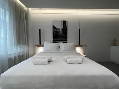 a bedroom with a large white bed with two pillows at The Dazzling Glimpse Acropolis Suites in Athens