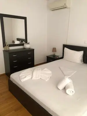 a bedroom with a bed with two towels on it at Cosy & Functional pied-à-terre in Athens