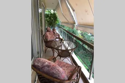 a balcony with chairs and a table on a balcony at Cosy & Functional pied-à-terre in Athens